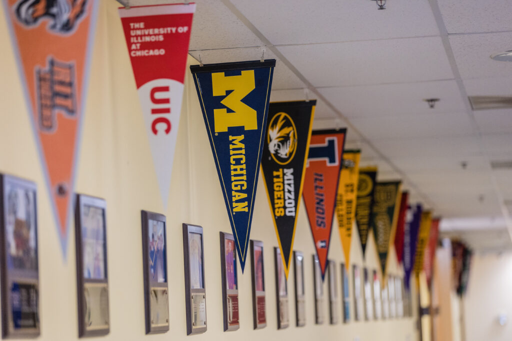 A hallway featuring college pennants