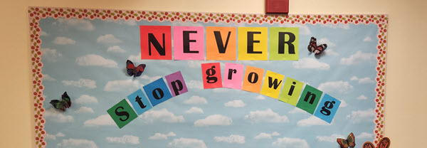 school bulletin board saying Never Stop Growing in rainbow letters