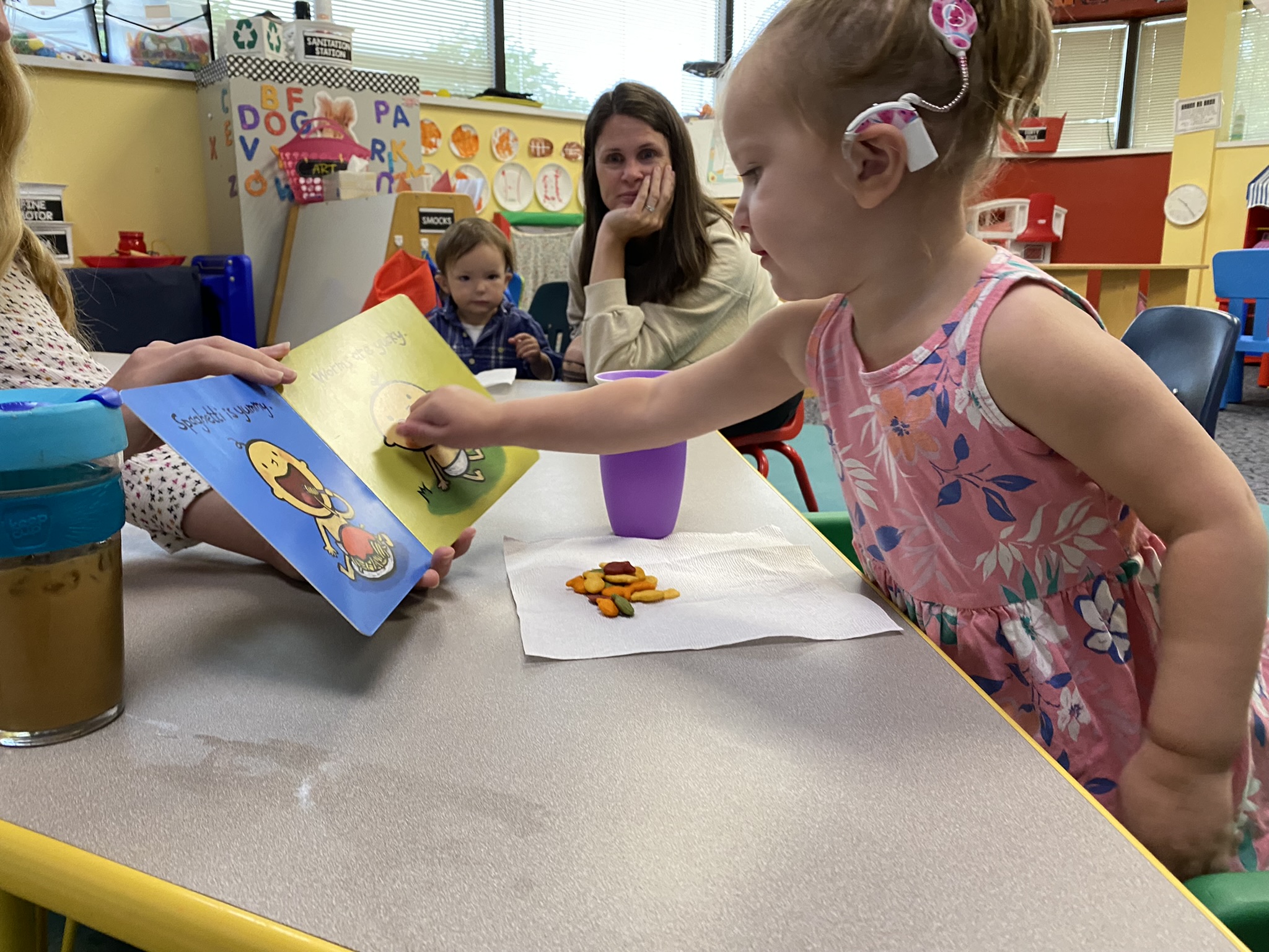 Young girl points to a puzzle board