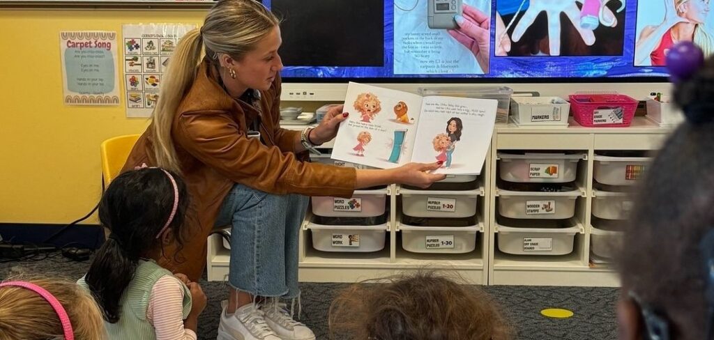 Woman reads a book to young children in a classroom