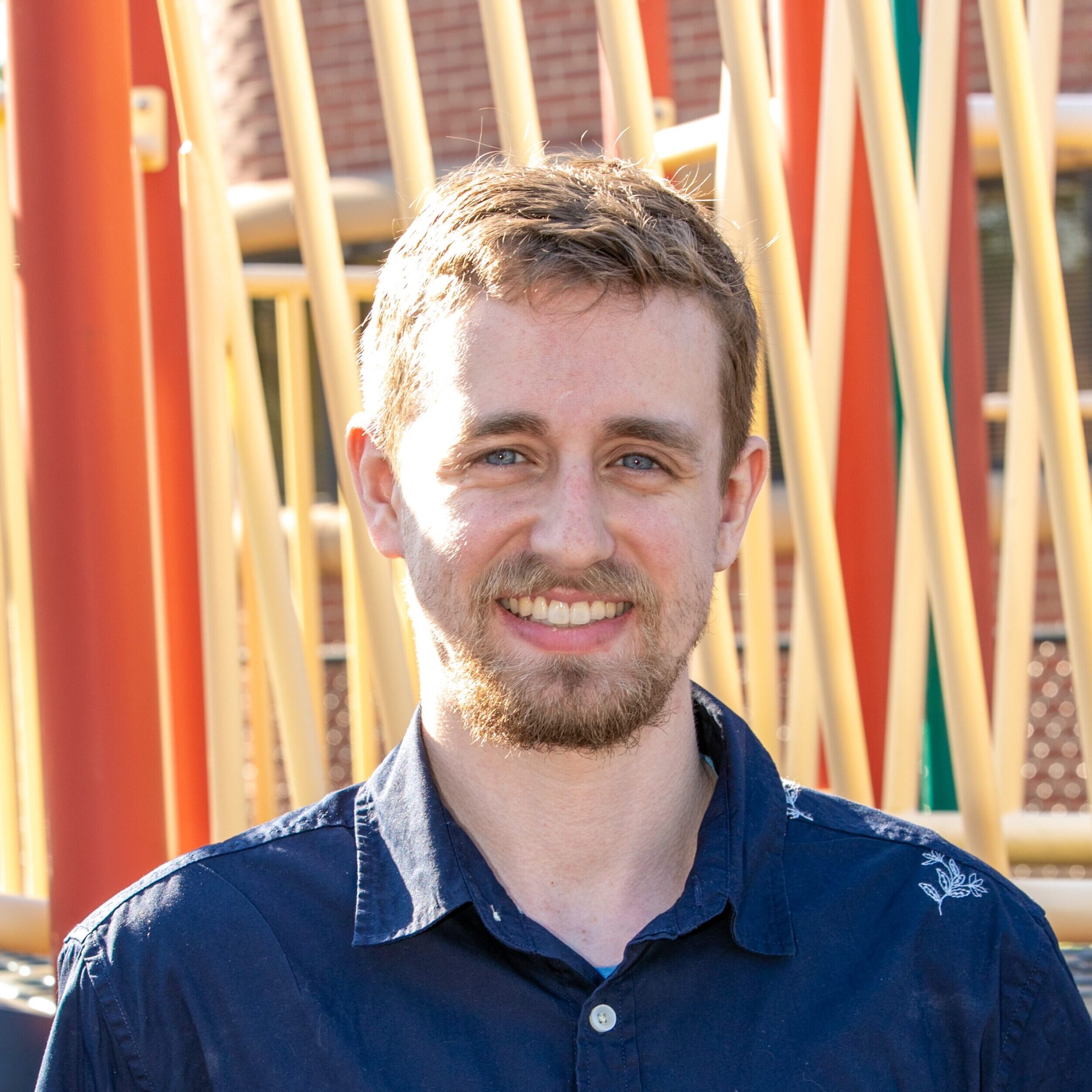 Blonde man smiling in a playground