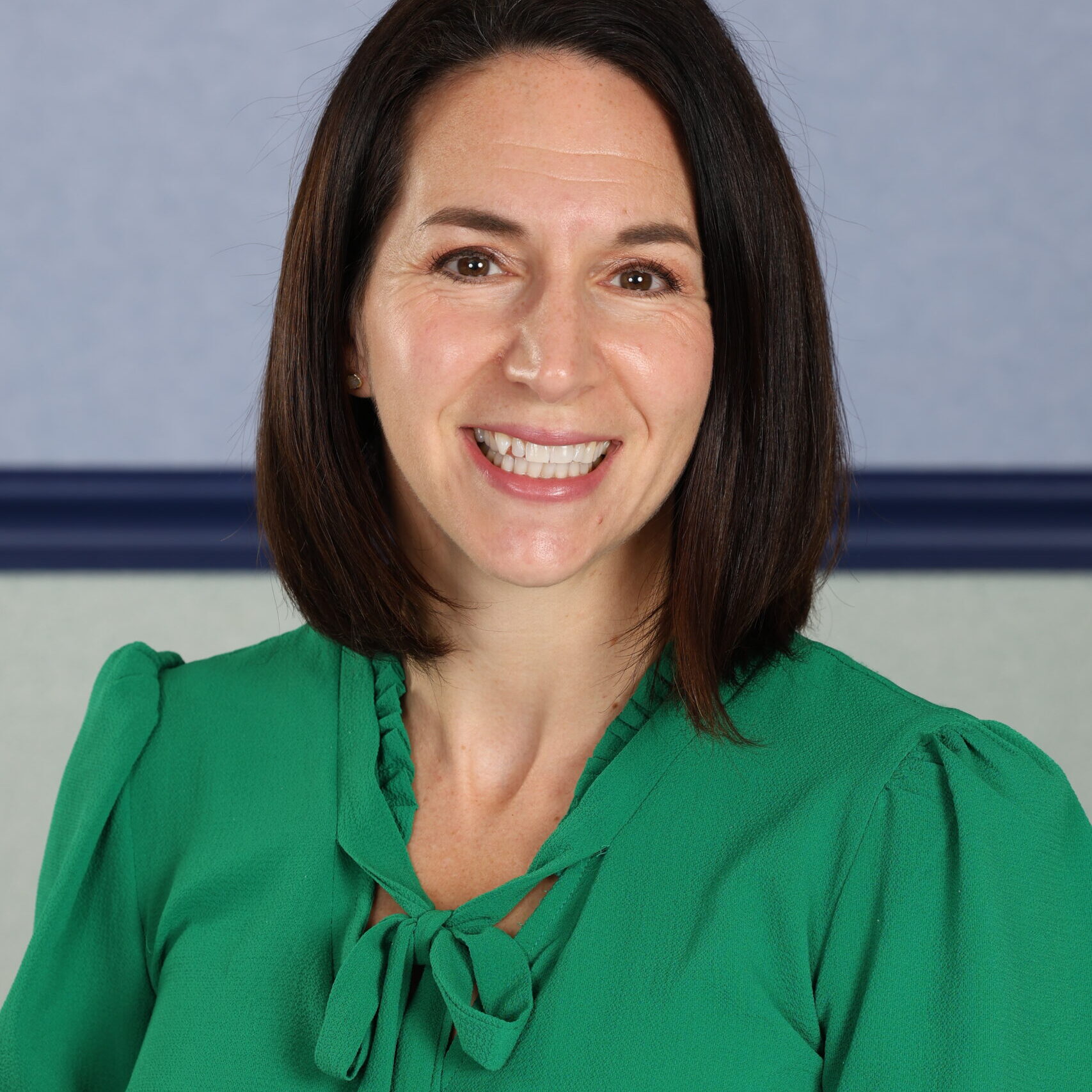 Brunette woman in green blouse